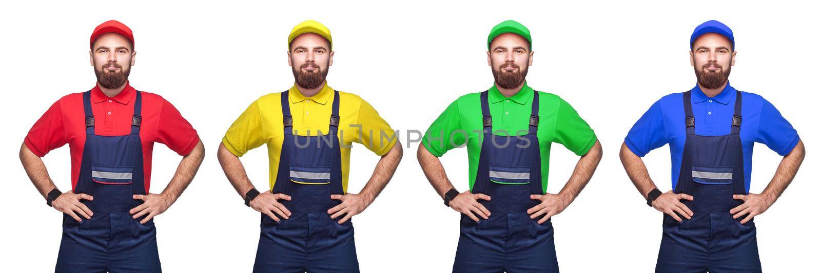 Portrait of young bearded confident with working clothes, four different color t-shirt and cap standing and holding hands on waist, smiling. indoor studio shot isolated on white background, copy space