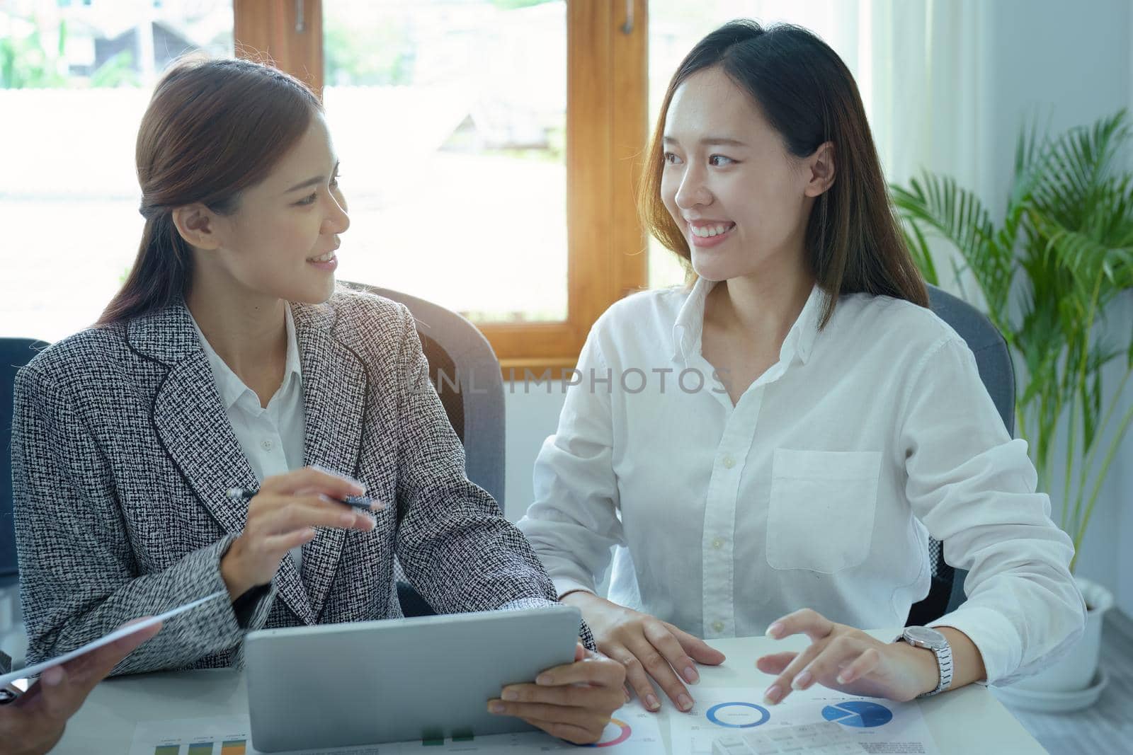 Planning to reduce investment risks, the image of a group of businesspeople working with partners is adjusting marketing strategies to analyze profitable and targeted customer needs at meetings by Manastrong