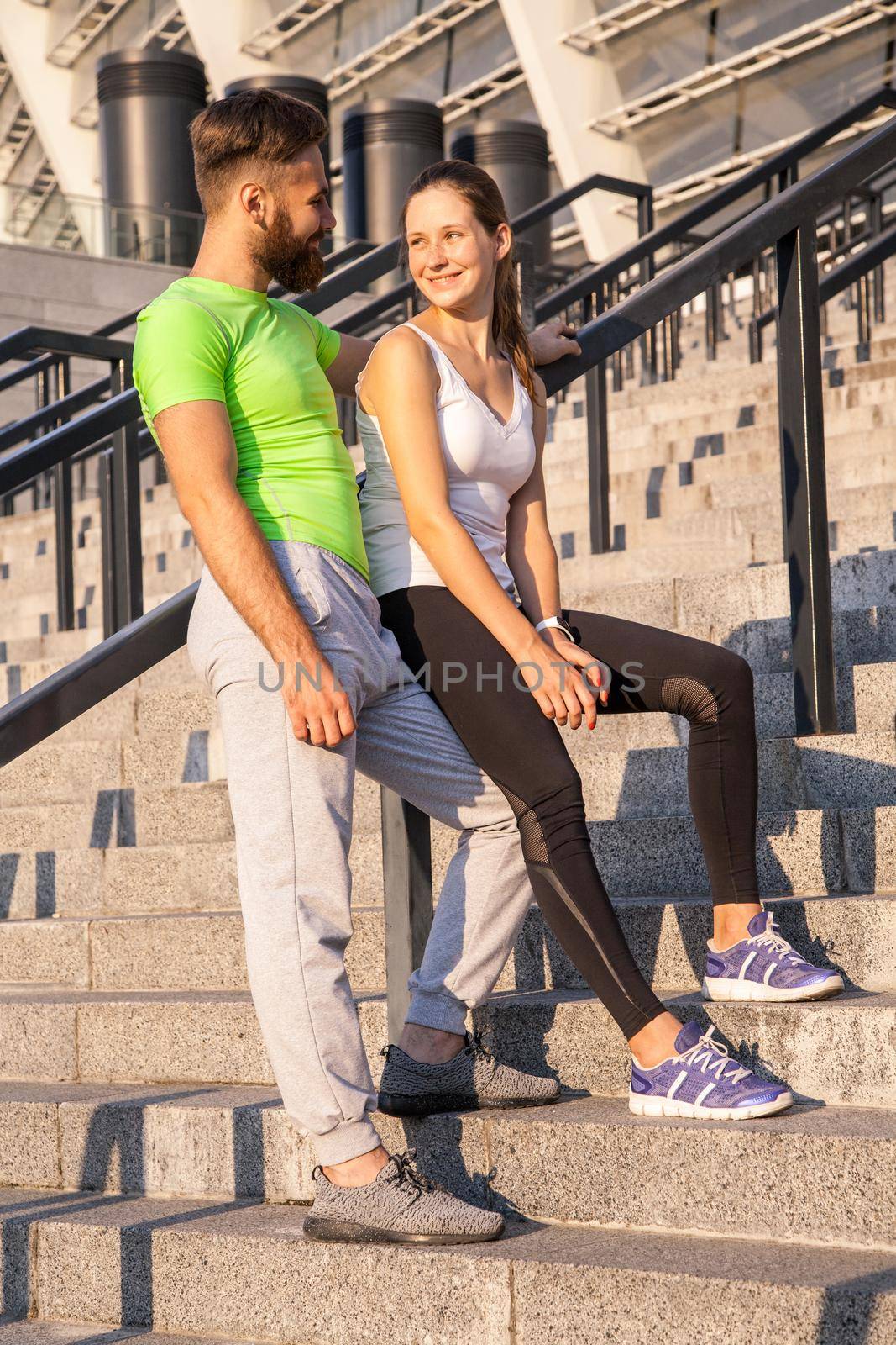 Young couple resting after running together. summer sport