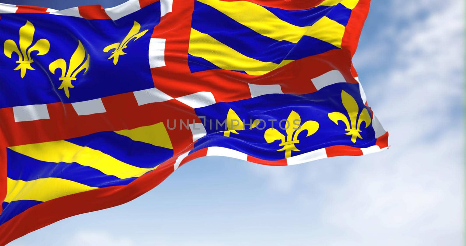 View of the Burgundy flag waving in the wind on a clear day. Burgundy is a historical territory of east-central France. Selective focus.