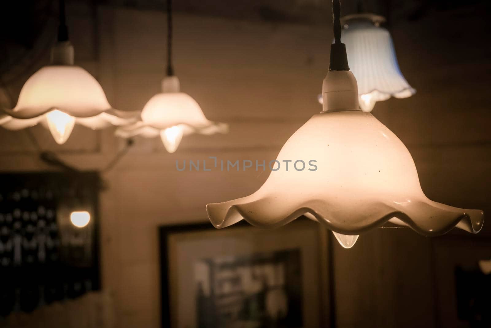 The vintage light bulb hanging decoration . The vintage hanging electric lamps. light in the dark hope concept idea. vintage technology background. by Petrichor