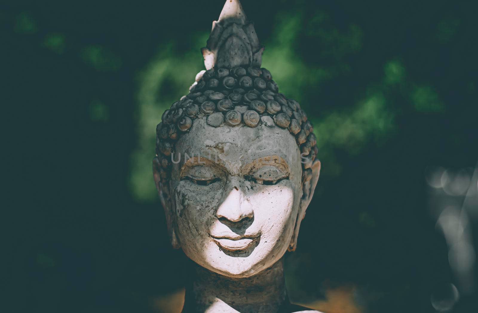 Statue of Buddha standing in meditation.Close up head face of statue Buddha.buddhism concept .peacefulness idea .lifestyle practise mind in clamness