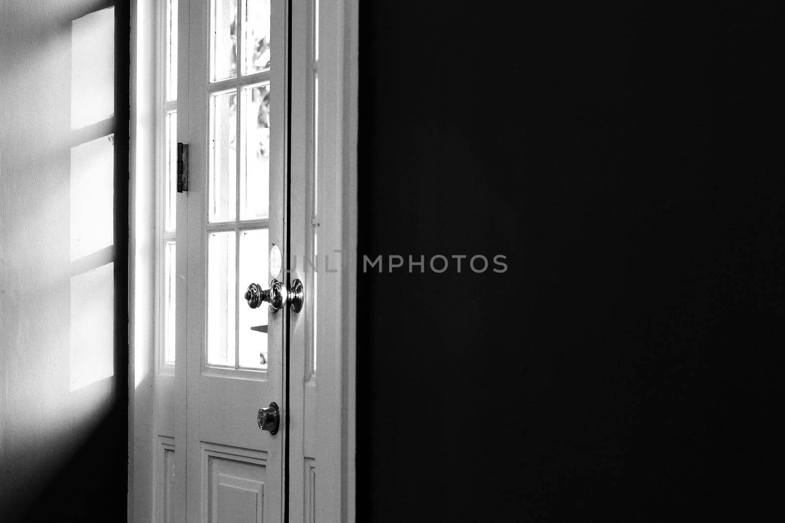 Light and shadow abstract.Sun shaded white wooden door frame and panel. Late afternoon sunlight provides lines and shade. by Petrichor