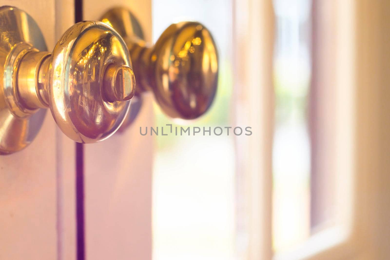close up of metal handle on a old wooden door,golden door knob. close up of metal handle on a old wooden door,golden door knob.