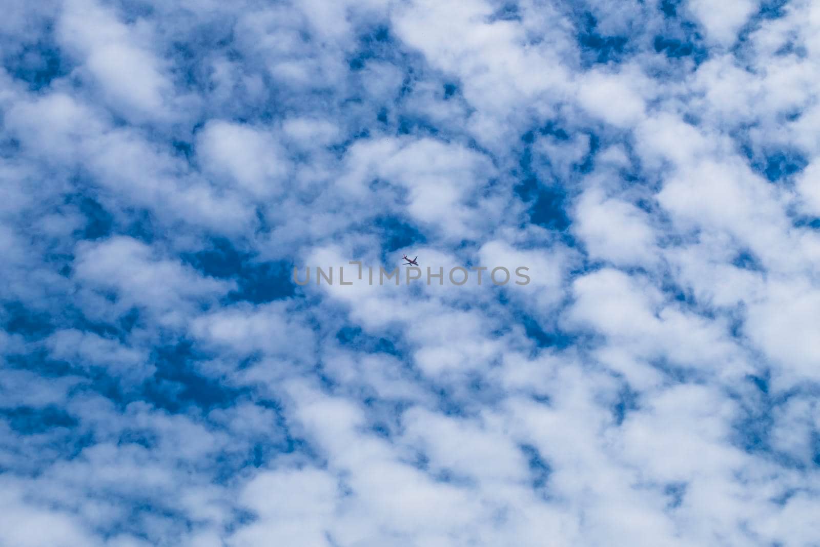 small Airplane flying in the blue sky among white clouds and sunlight . Airplane destination background. Adventure time concept . lost and found concept idea