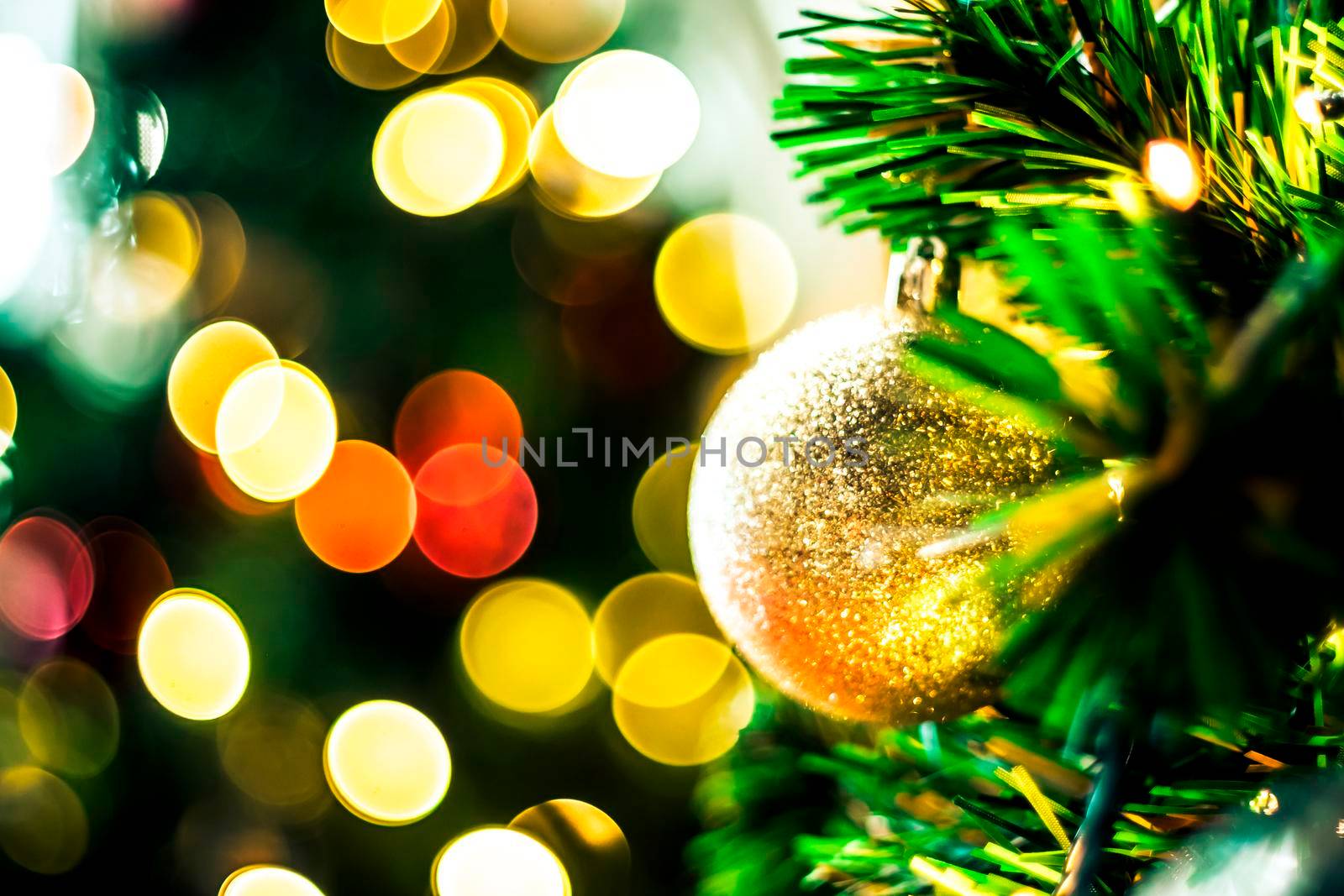 Decorated Christmas tree on blurred varicolored new year's background  . Christmas Ornament On Wooden Background With Snowflakes, Greeting card Merry Christmas and Happy New Year . by Petrichor