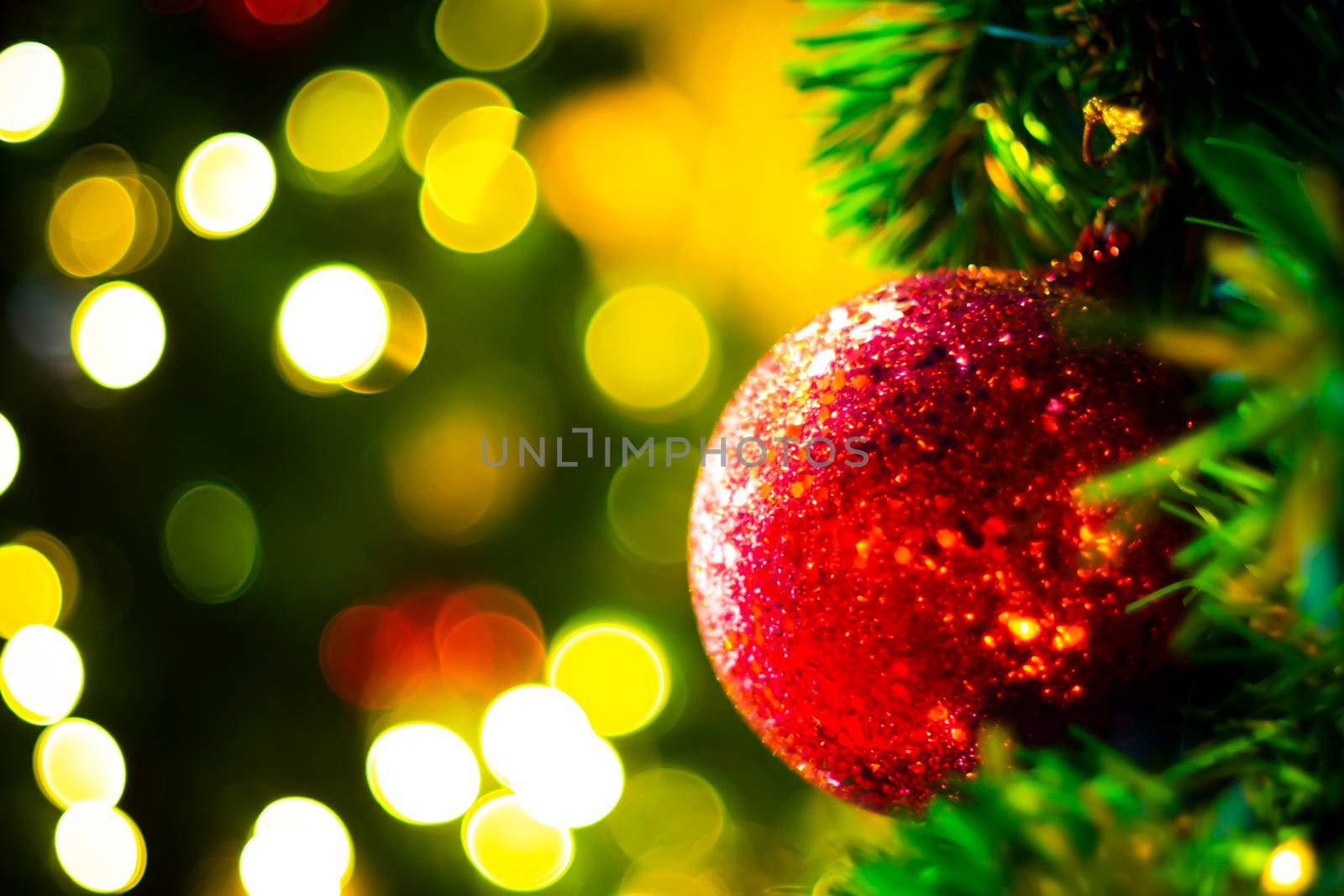 Decorated Christmas tree on blurred varicolored new year's background  . Christmas Ornament On Wooden Background With Snowflakes, Greeting card Merry Christmas and Happy New Year .