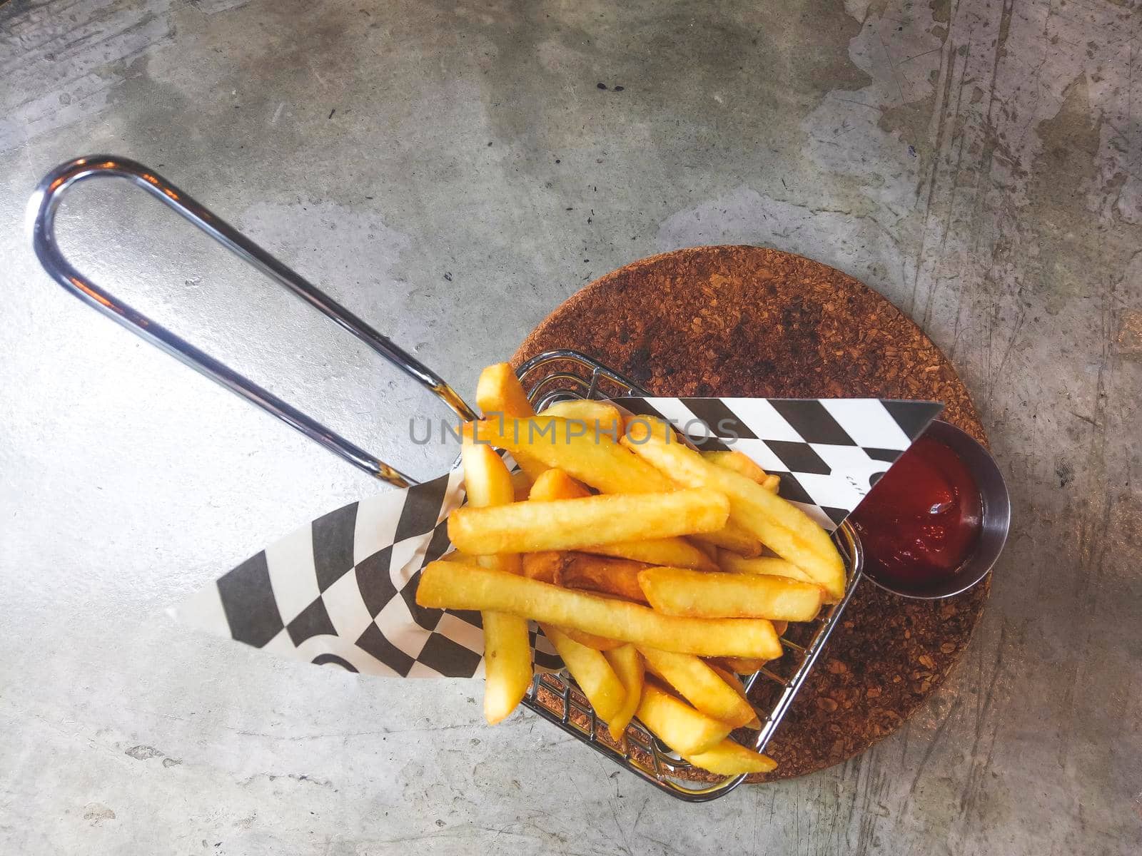French fries in a cardboard scoop.French fries in basket with ketchup and sauce isolated on rustic gray background. healthy concept .lose weight background