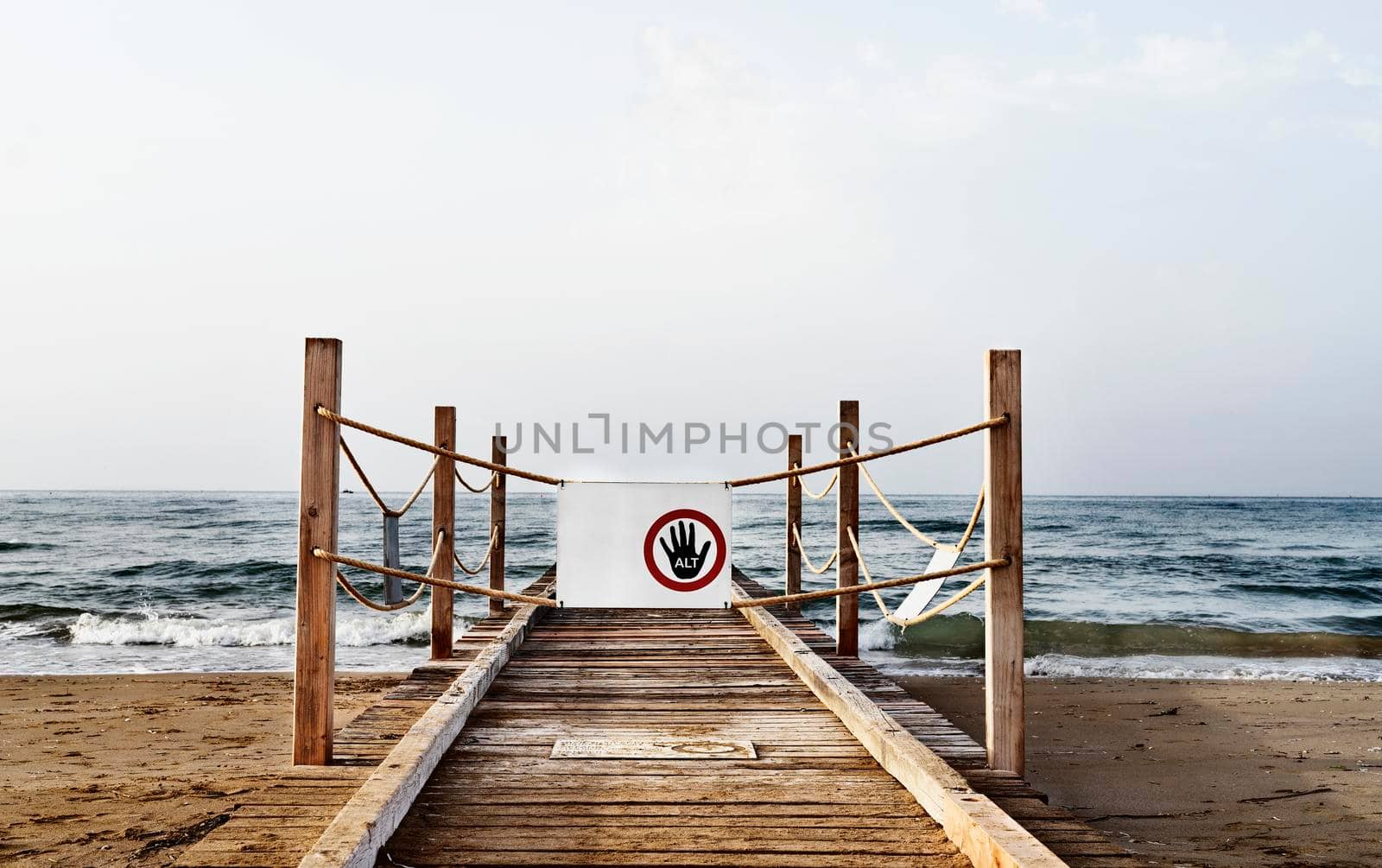 Wooden pier at the sea with  danger sign -no access - 