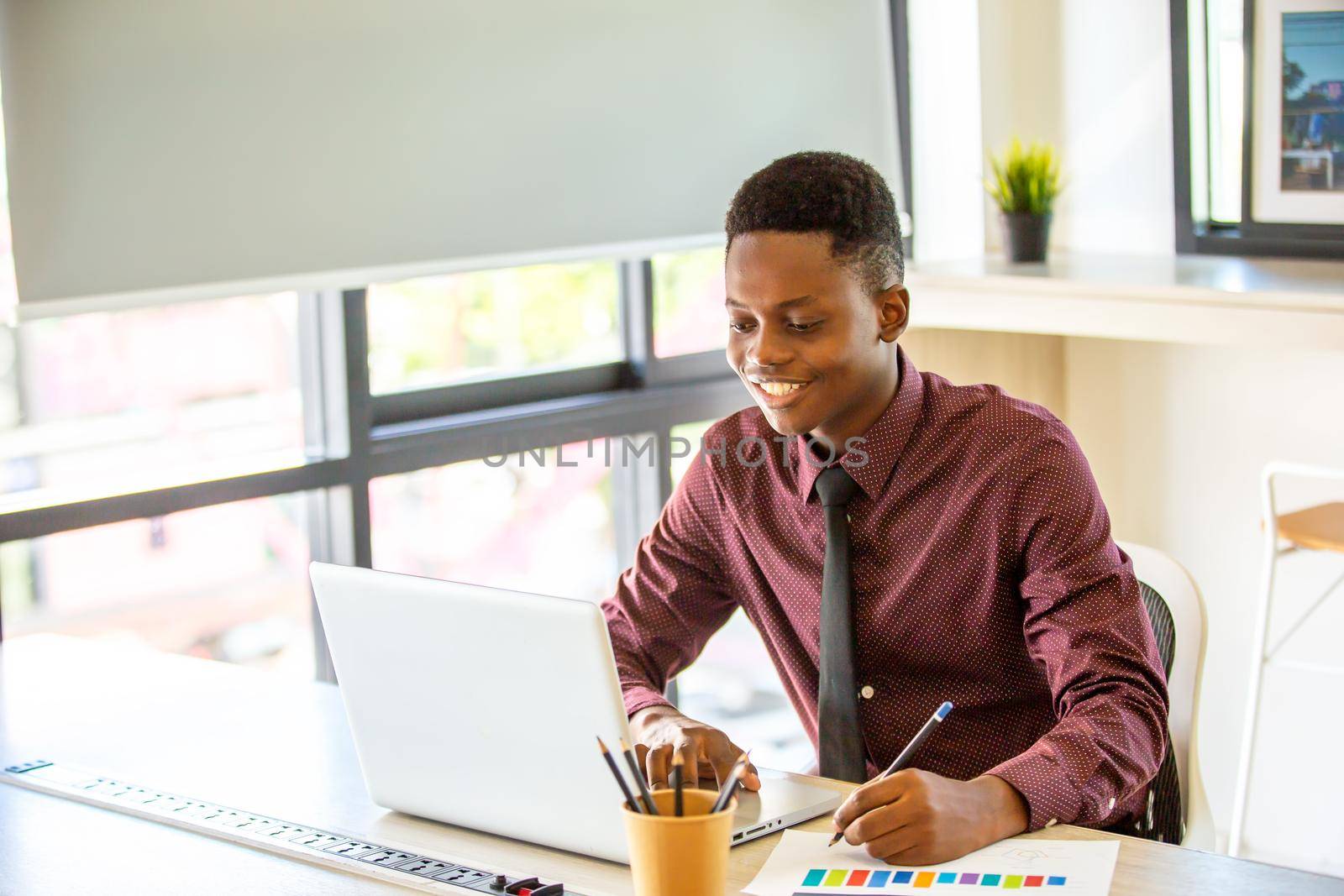 Black man watching educational webinar on laptop, studying, preparing for exam, talk in video chat