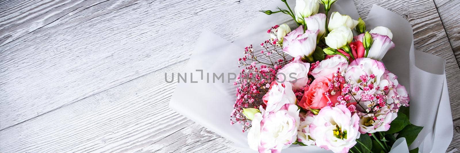 top view of bouquet of flowers on white wooden background. copy space for text, holiday concept, greeting card. cover