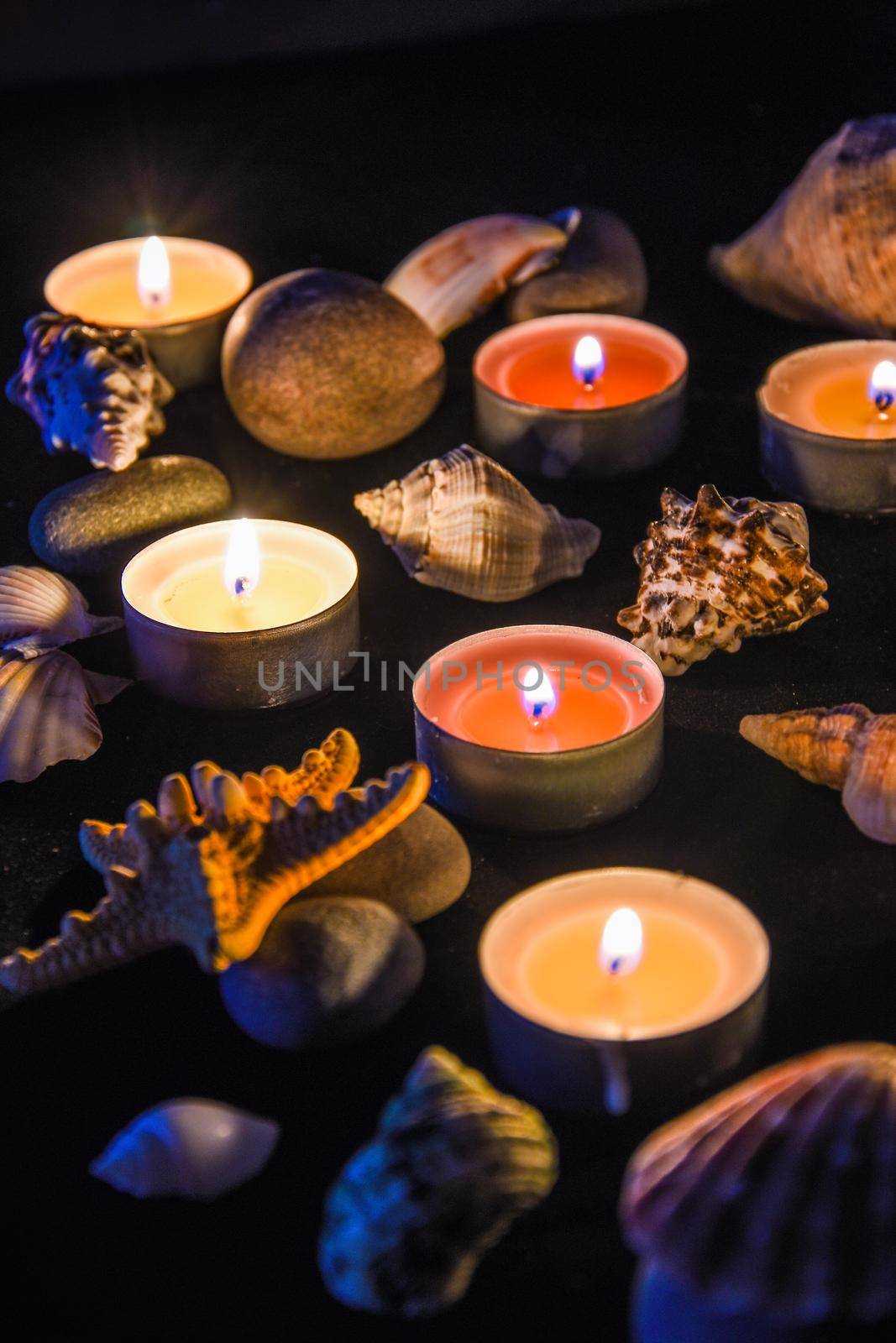 Candles, stones and shell in spa, light at night by anna_stasiia