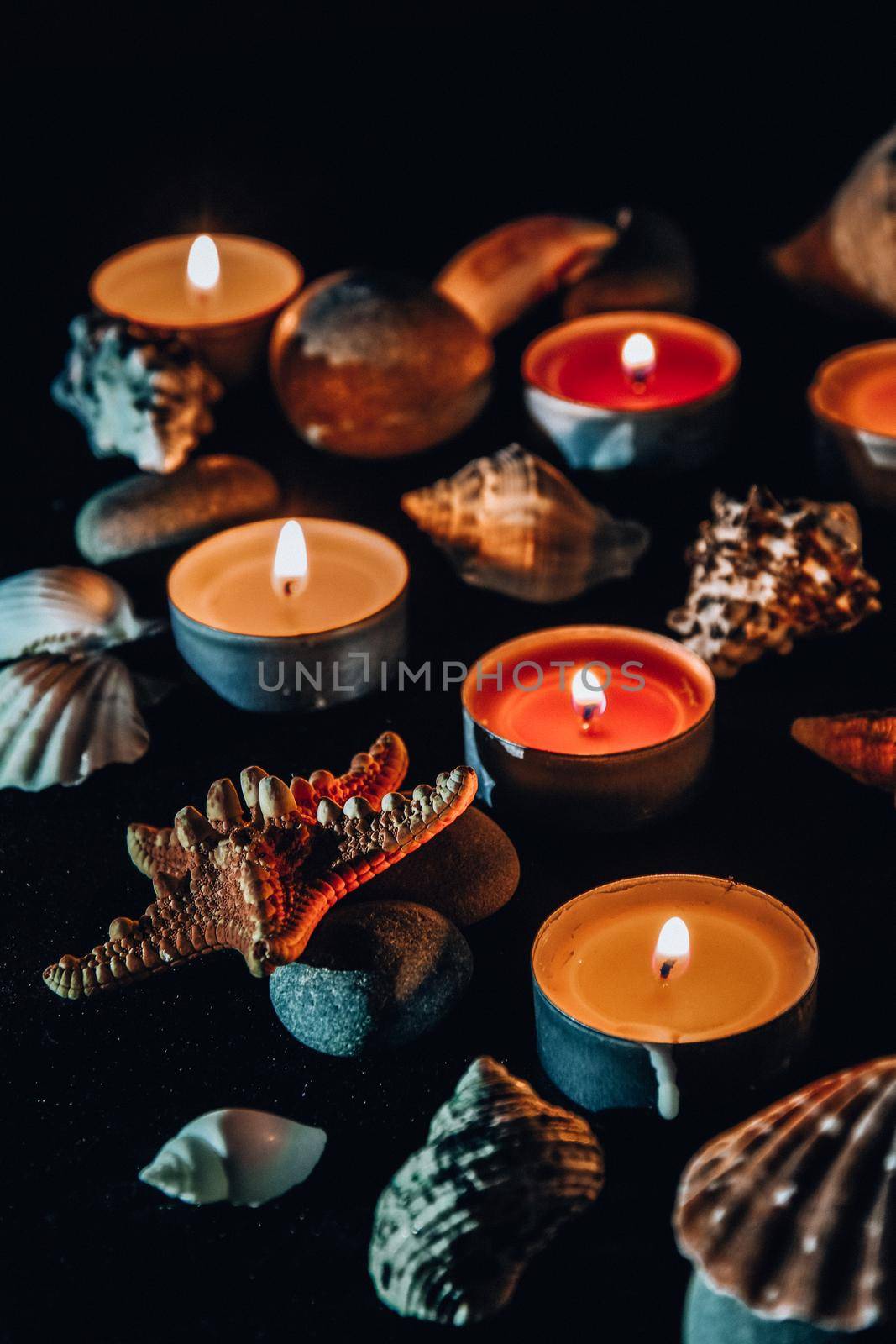 Candles, stones and shell in spa, light at night by anna_stasiia