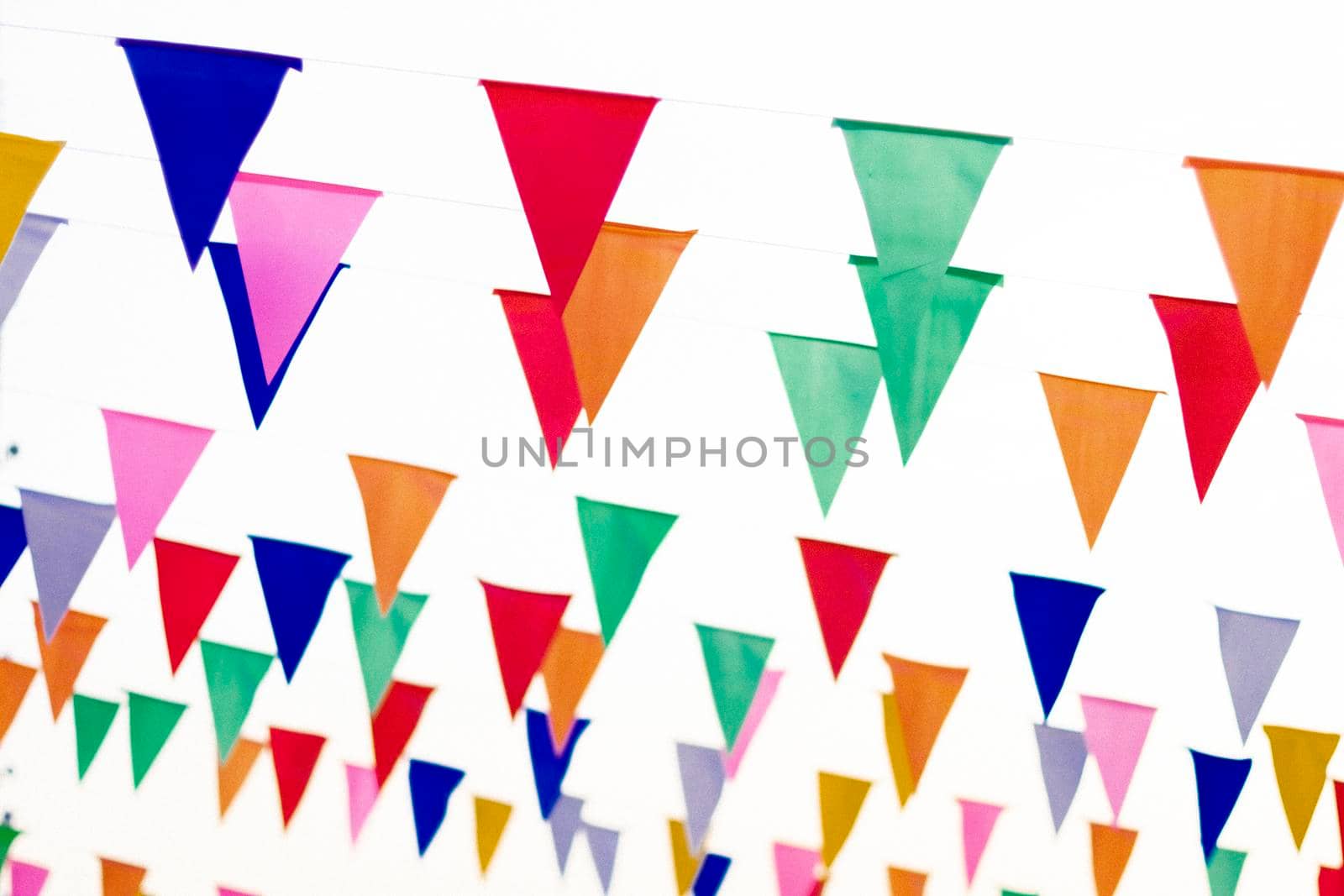 Colorful paper bunting party flags isolated on white background  . Carnival garland with flags. Decorative colorful party pennants for birthday celebration, festival and fair decoration. Holiday by Petrichor