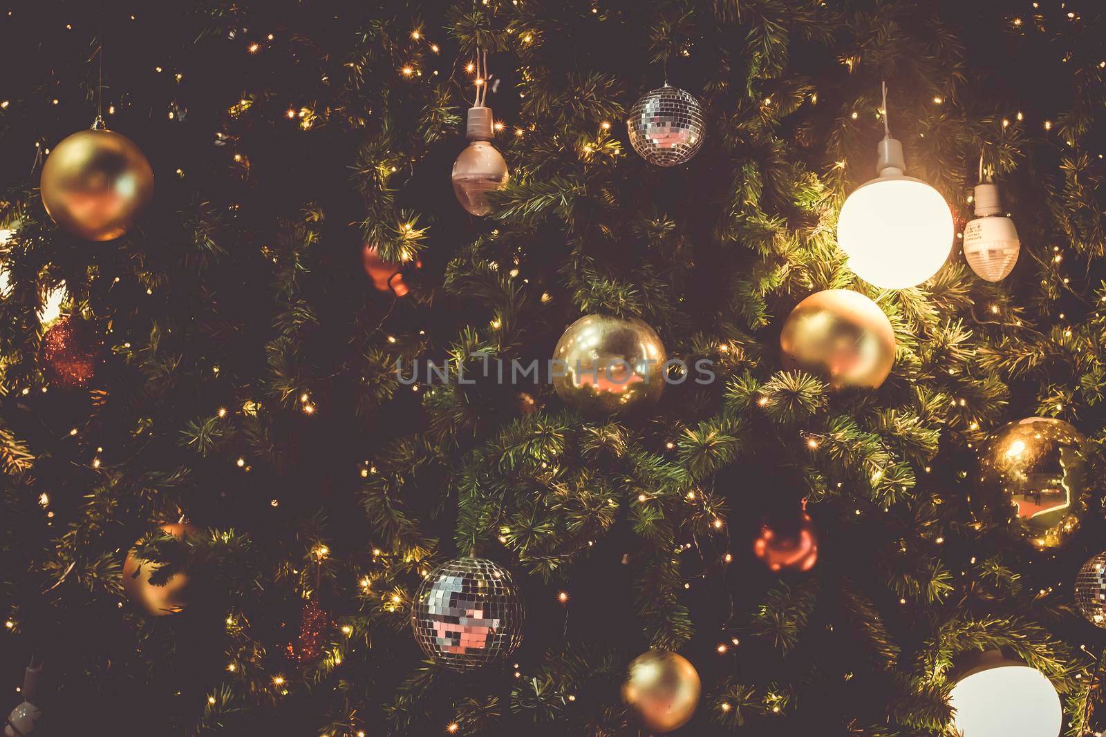 Decorated Christmas tree on blurred varicolored new year's background  . Christmas Ornament On Wooden Background With Snowflakes, Greeting card Merry Christmas and Happy New Year .