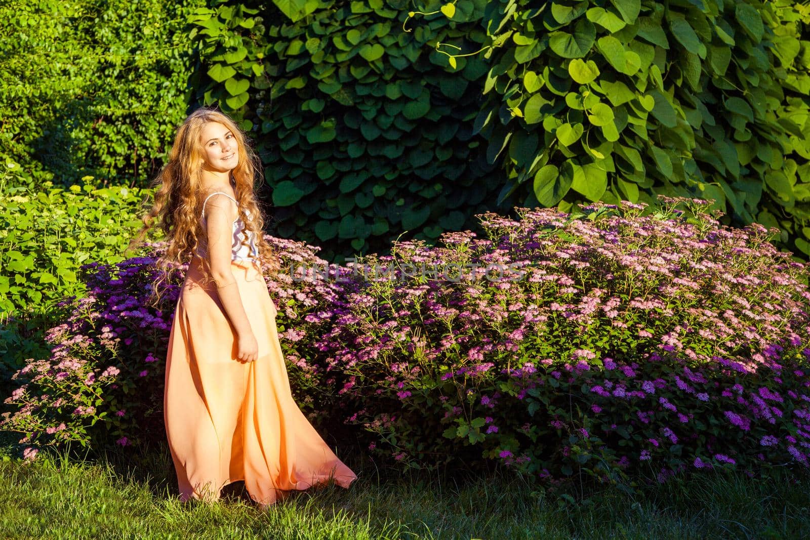 young girl standing and enjoying on summertime in the park