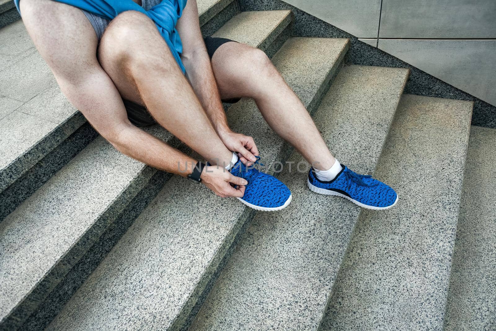 Side view. Tie shoelaces. pause after running. Outdoor shot