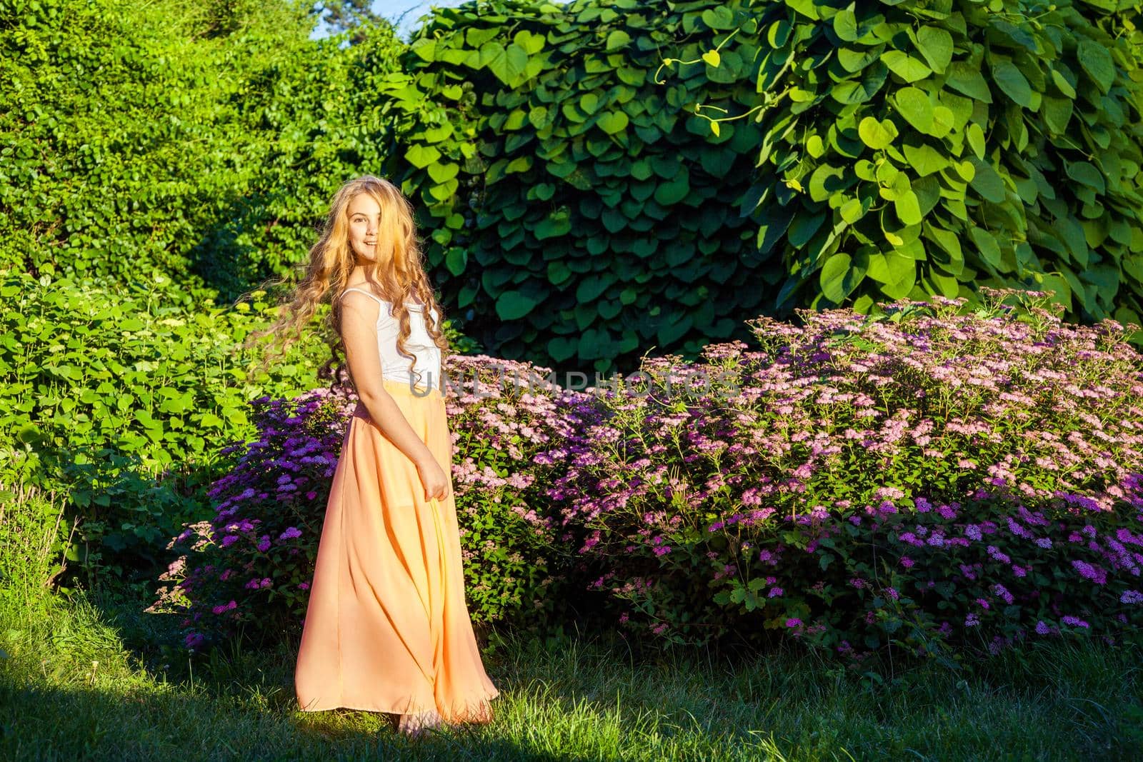 young girl standing and enjoying on summertime in the park