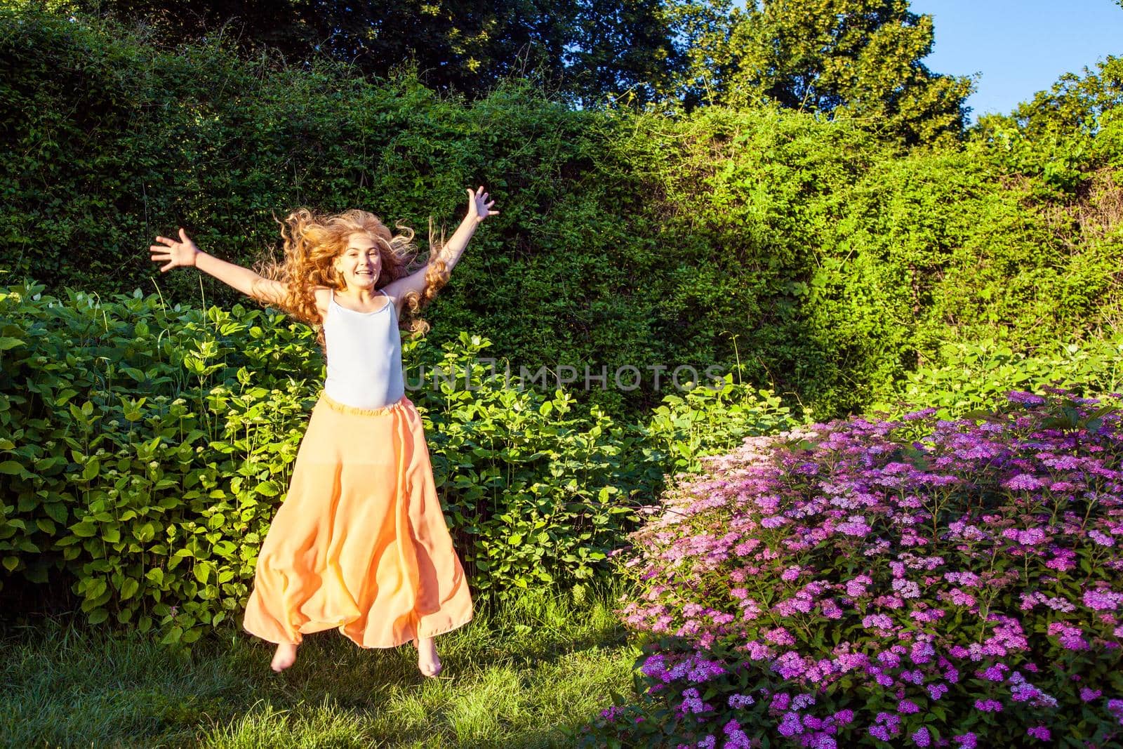 young girl standing and enjoying on summertime in the park