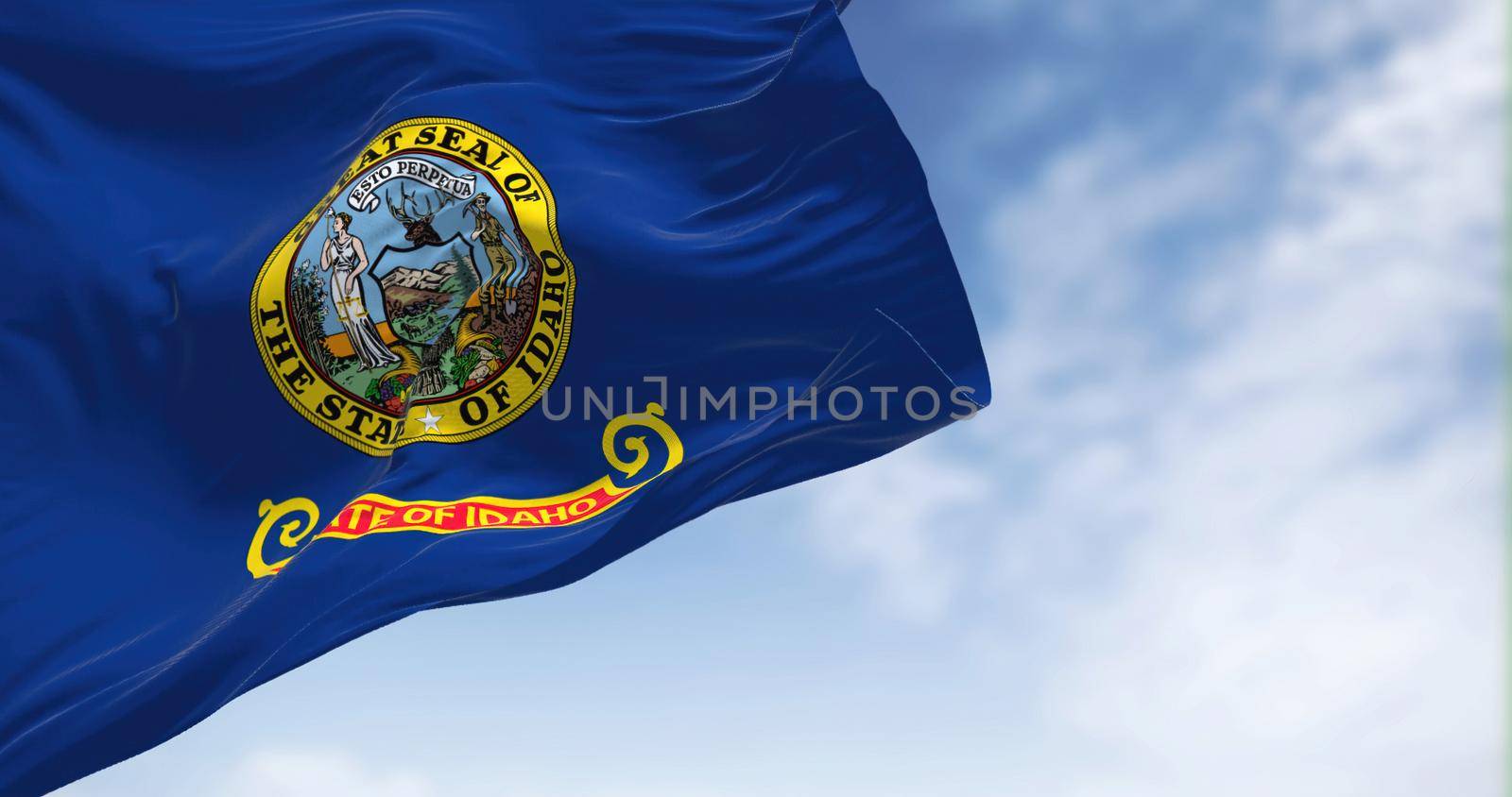 The US state flag of Idaho waving in the wind. Idaho is a state in the Pacific Northwest region of the United States. Democracy and independence.