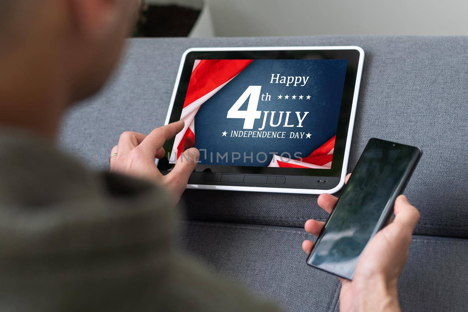 man searching website with information of the celebration of Independence Day hands of a man looking in web a site with information of 4th July. High quality photo