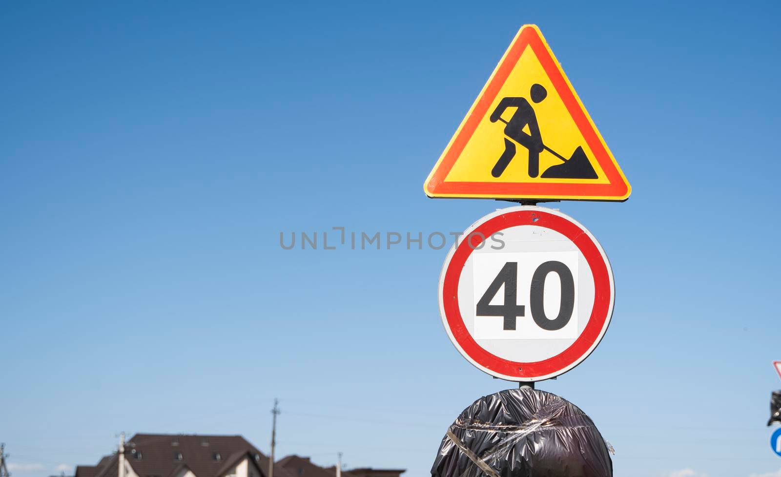 Road marking on the road, warning signs. Direction of detour, sign speed limit 40 and roadworks. Road signs denoting road repairs, speed limit up to 40, detour. by vovsht