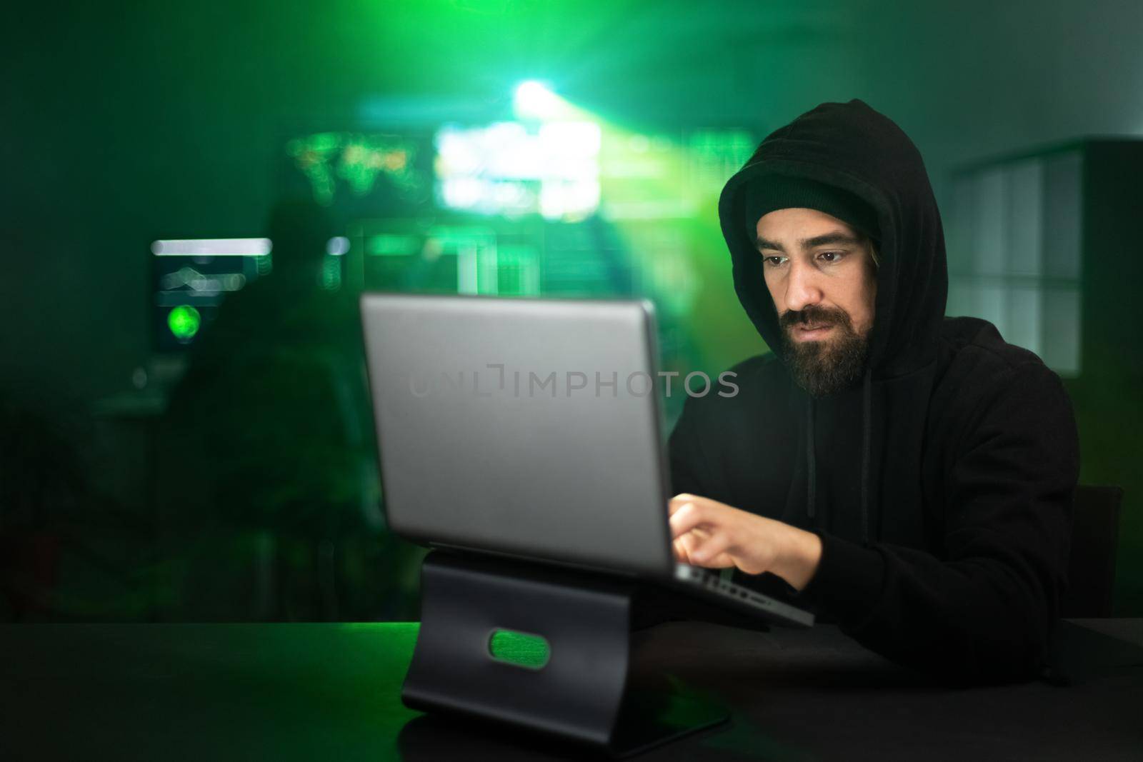 Male hacker using laptop typing bad data into computer online system. Copy space. Hacking and malware concept.