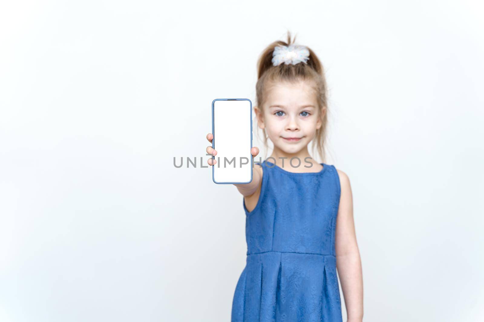 kid posing in the studio with a smartphone by Lena_Ogurtsova