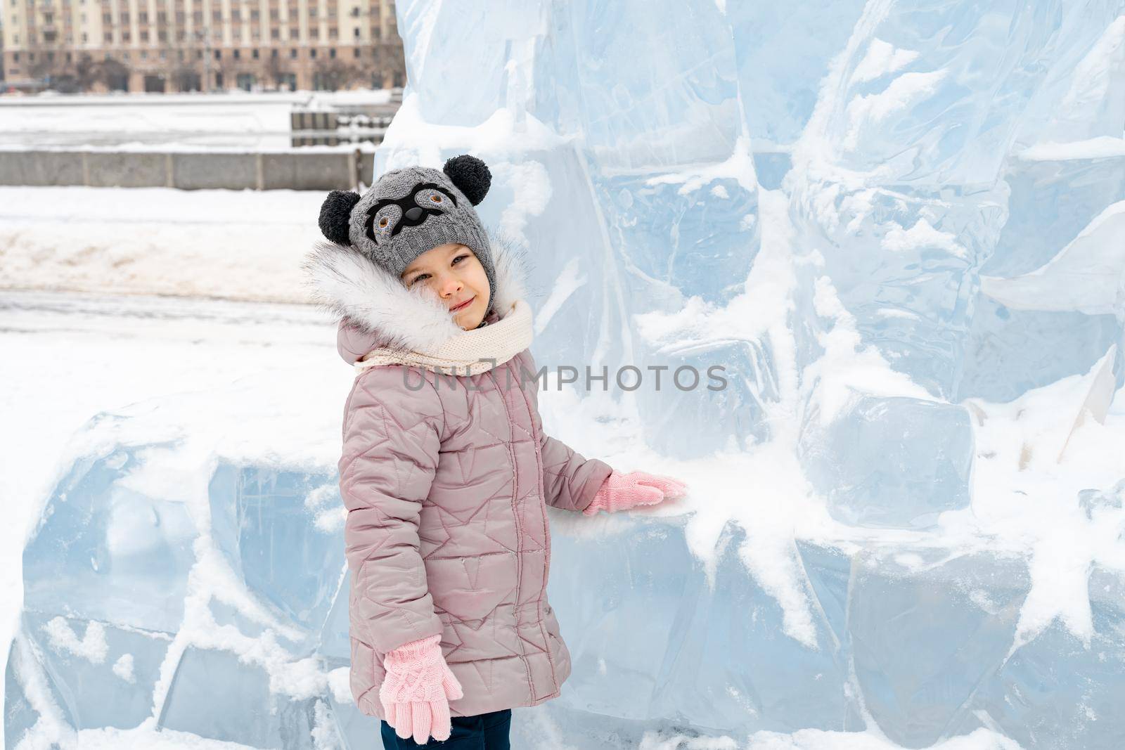 portrait of a happy little girl on a winter snowy day