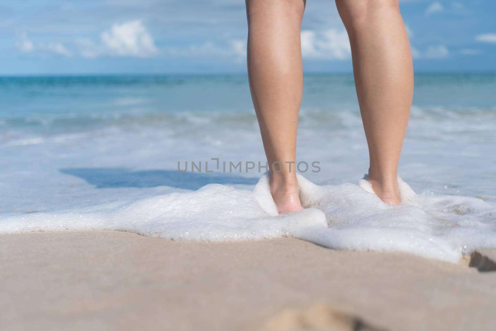 Summer vacation concept barefoot on sand at beach with copyspace. by Suwant