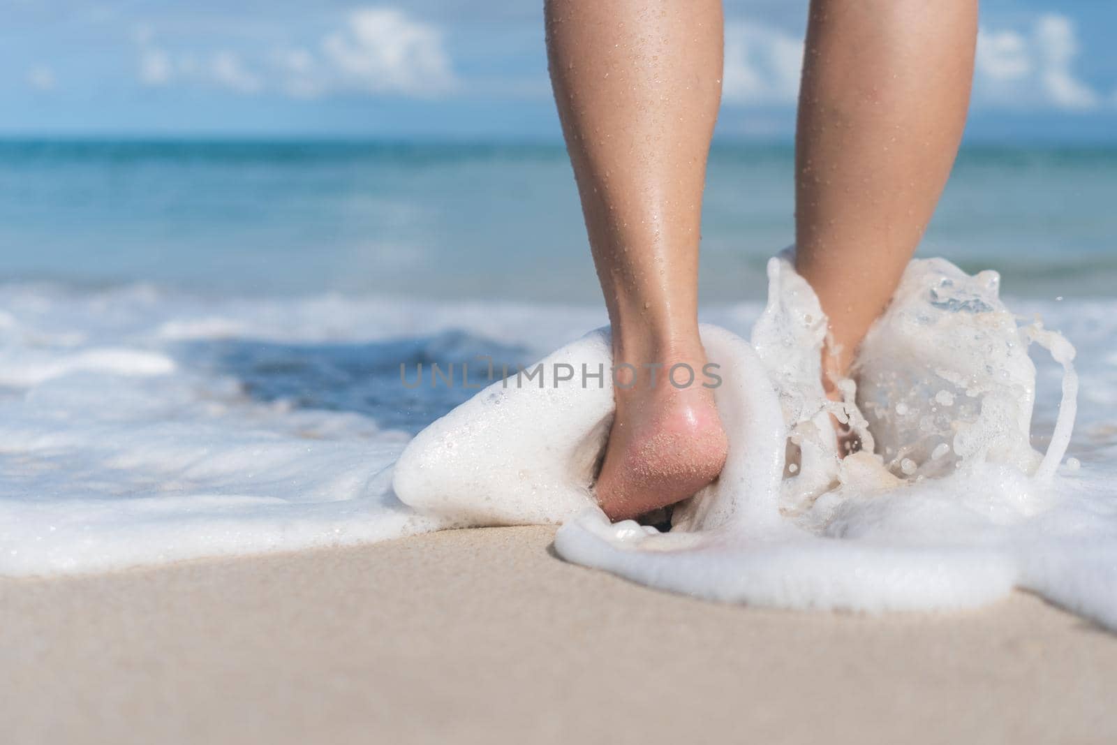Summer vacation concept barefoot on sand at beach with copyspace background