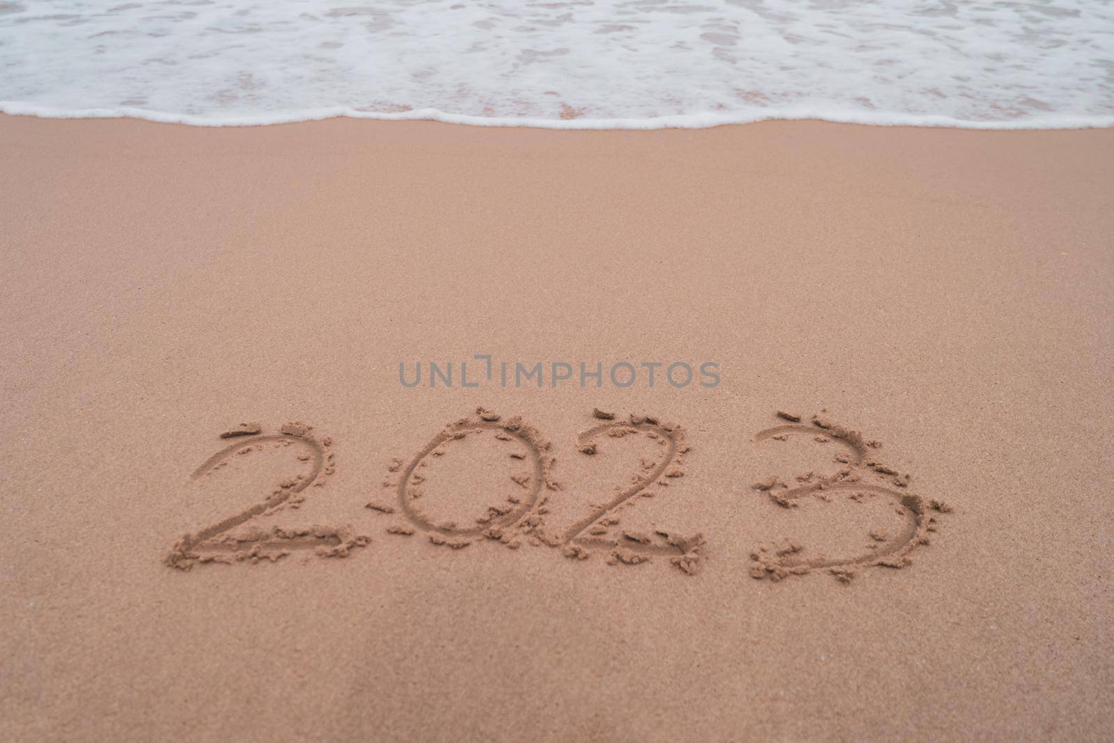 New year 2023 is coming with sunset beach background. New start for planing or set new resolution in life.  by Suwant