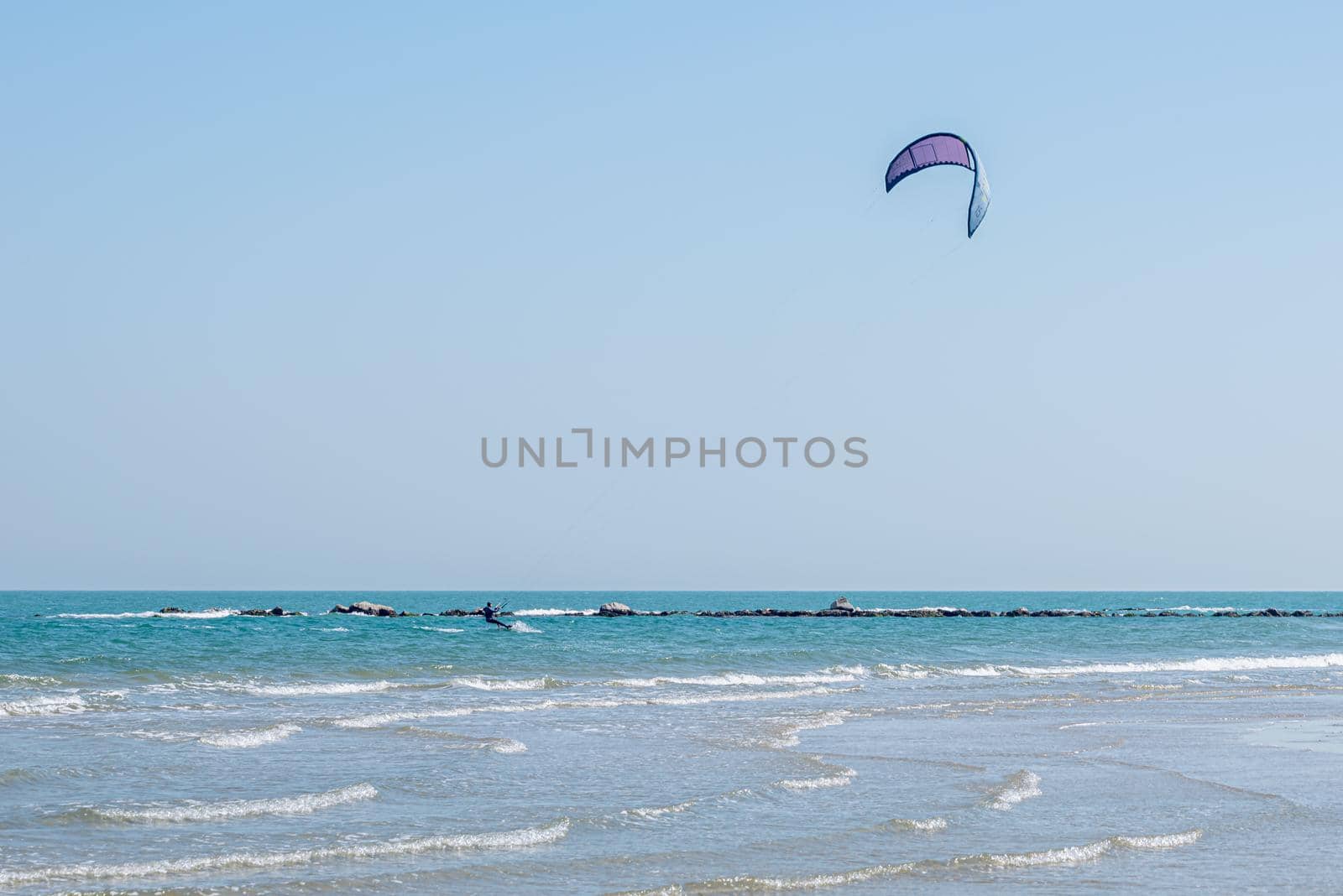 Kite surfing in Pesaro, Marche region of Italy, on the Adriatic sea during a sunny and windy summer day