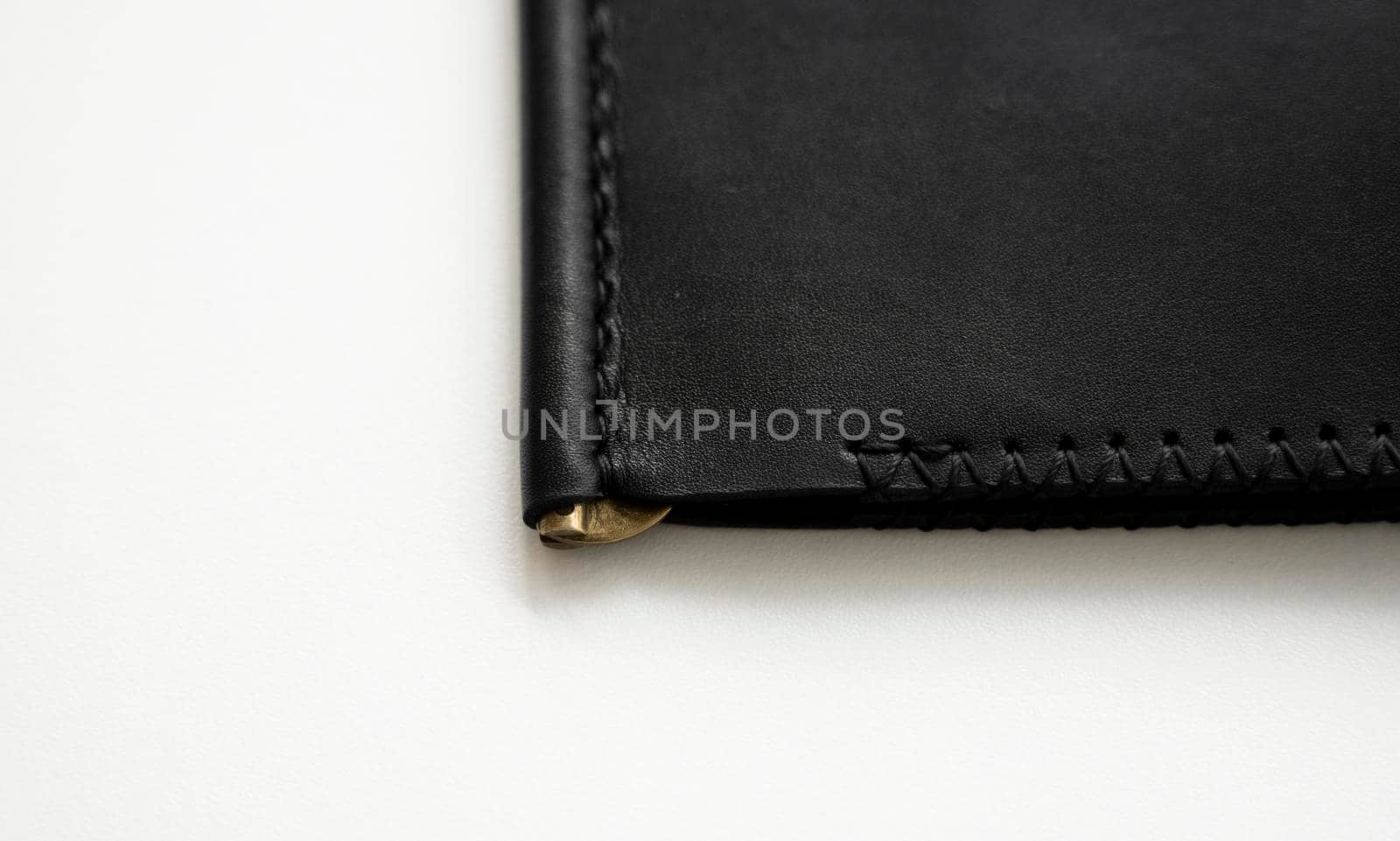 Details of empty classic black leather handmade money clip wallet on white background. Leather accessories. by vovsht