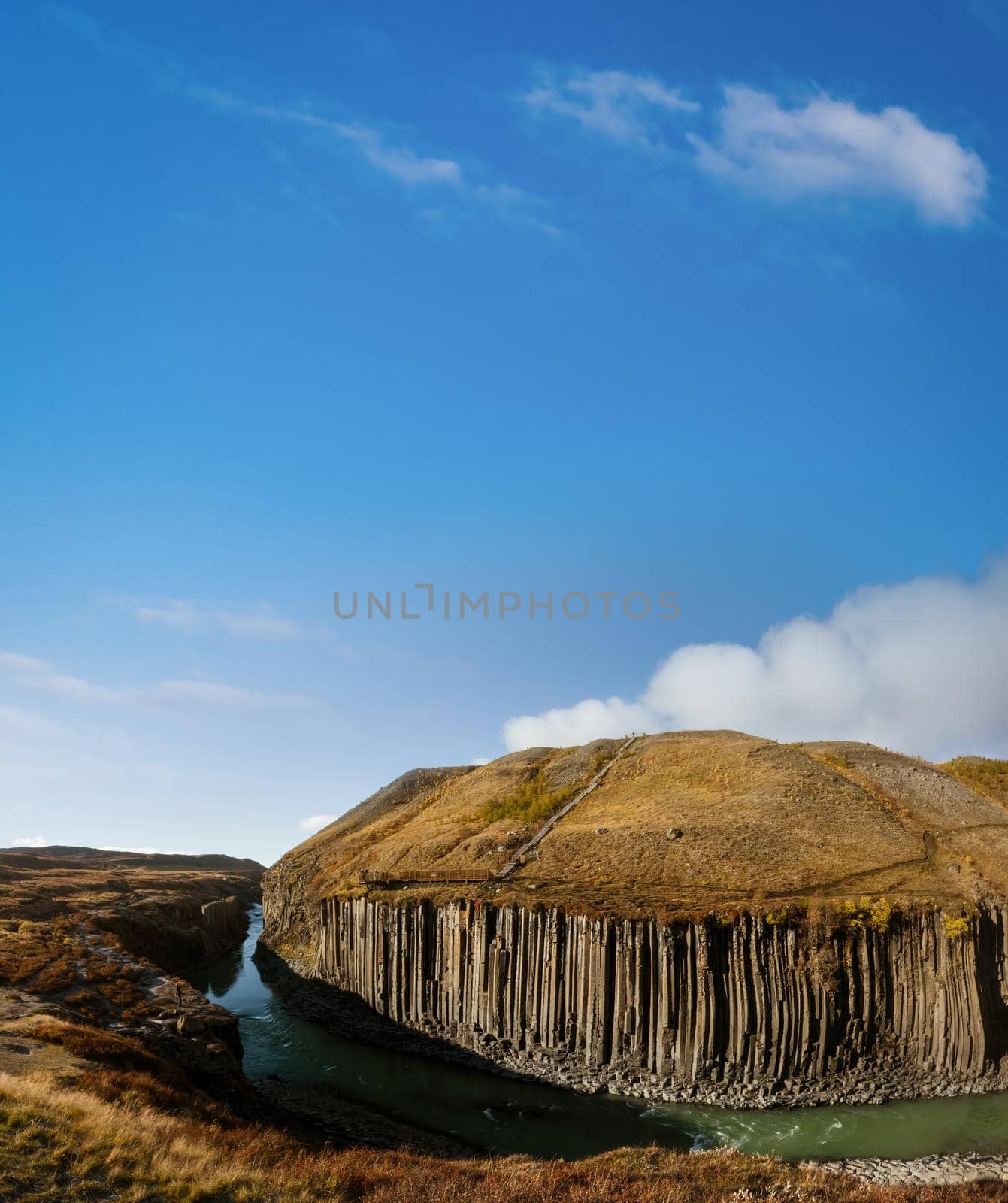 Fjadrargljufur basaltic canyon panorama with iron viewpoint under the blue sky