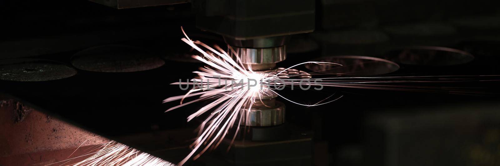 Bright sparks from metal turning, close-up. Laser cutting, mechanical engineering. Manufacturing complex parts