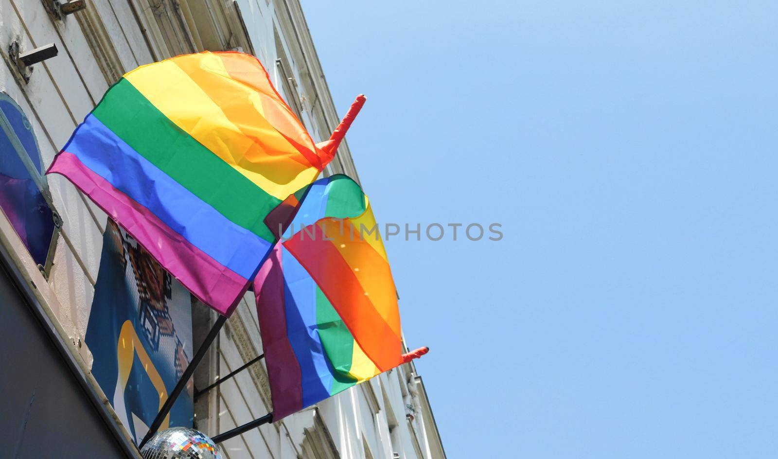 Pride rainbow lgbt gay flag being waved on sky background by Whatawin