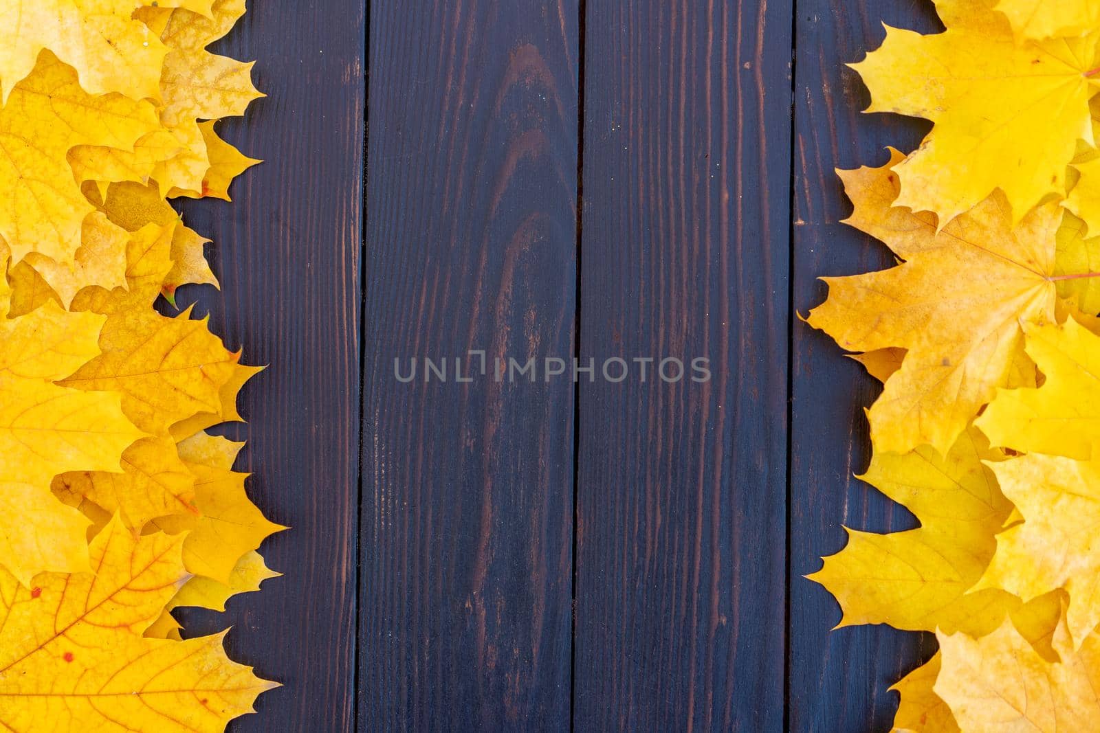 Autumn leaves frame on two left and right side wooden background top view Fall Border yellow and Orange Leaves vintage wood table Copy space. Mock up for your design. Display for product or text