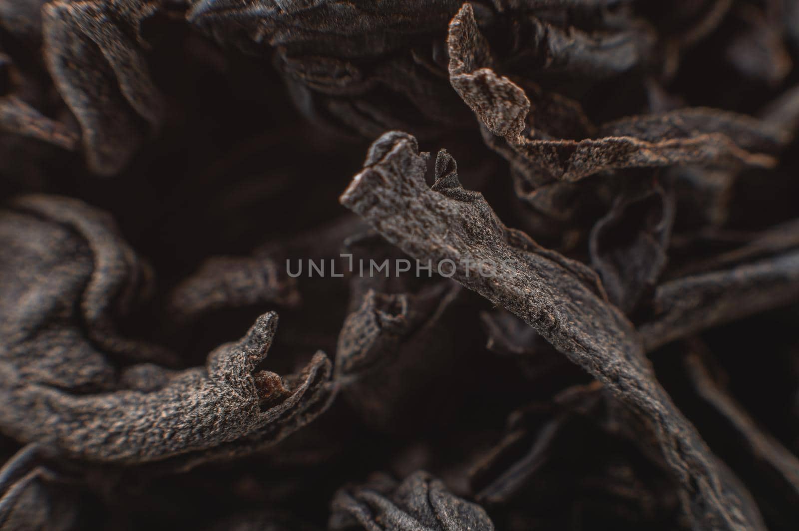 Dry black tea leaves close up. Macro background of tea production.