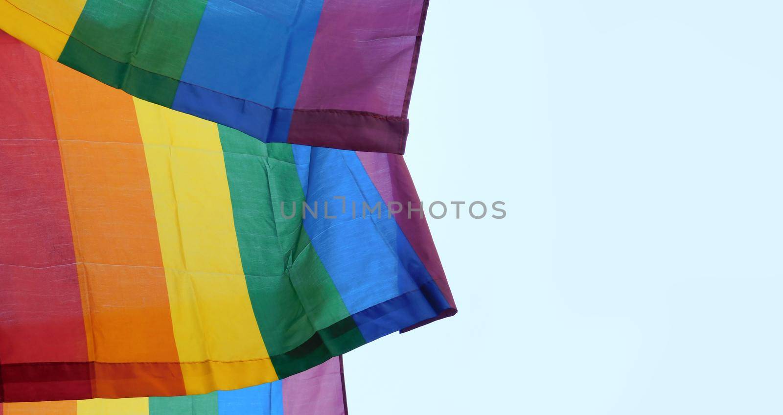 The rainbow flag, gay pride or LGBTQ symbol on light