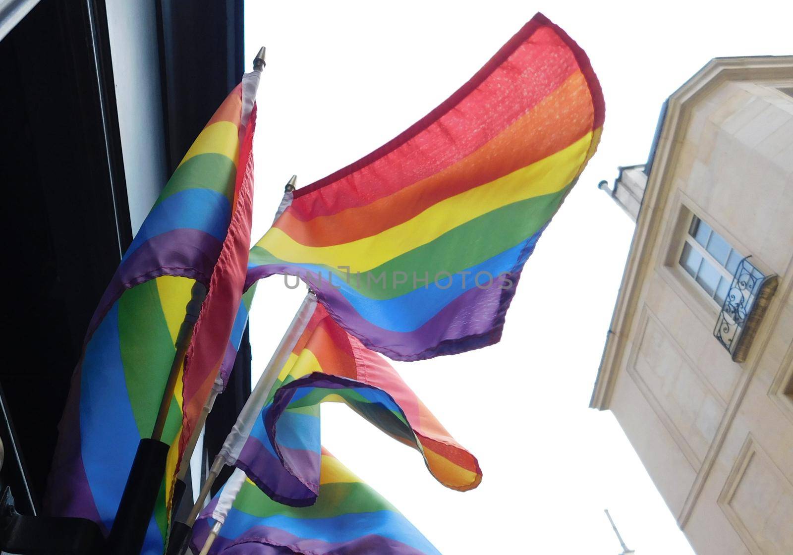 Pride rainbow lgbt gay flag being waved on sky background by Whatawin