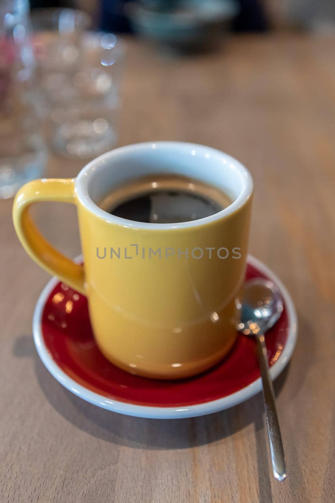 a yellow mug morning coffee on a red saucer on the table by bySergPo