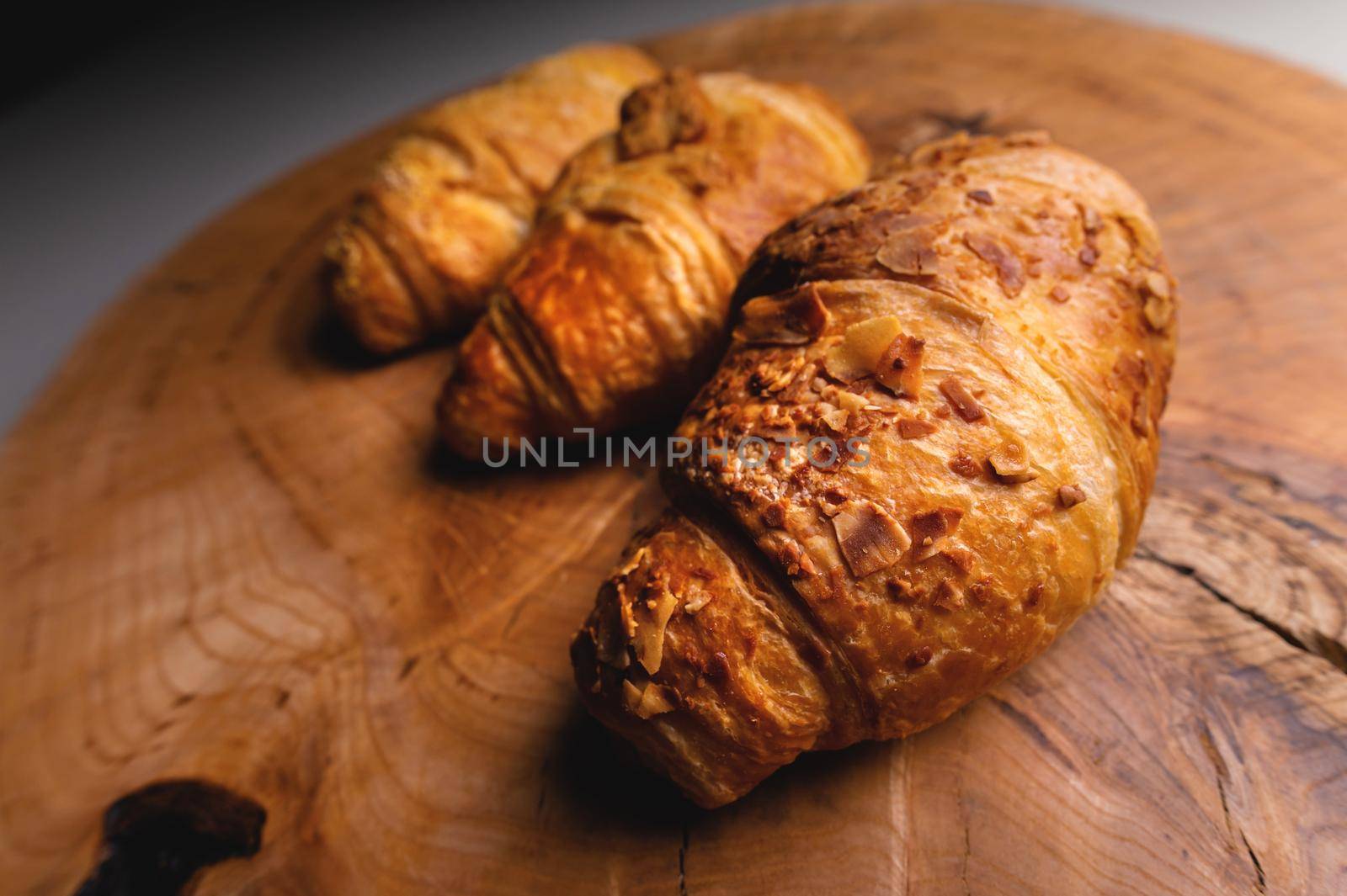 Close up of a bunch of delicious croissants on a dark background. Homemade croissants