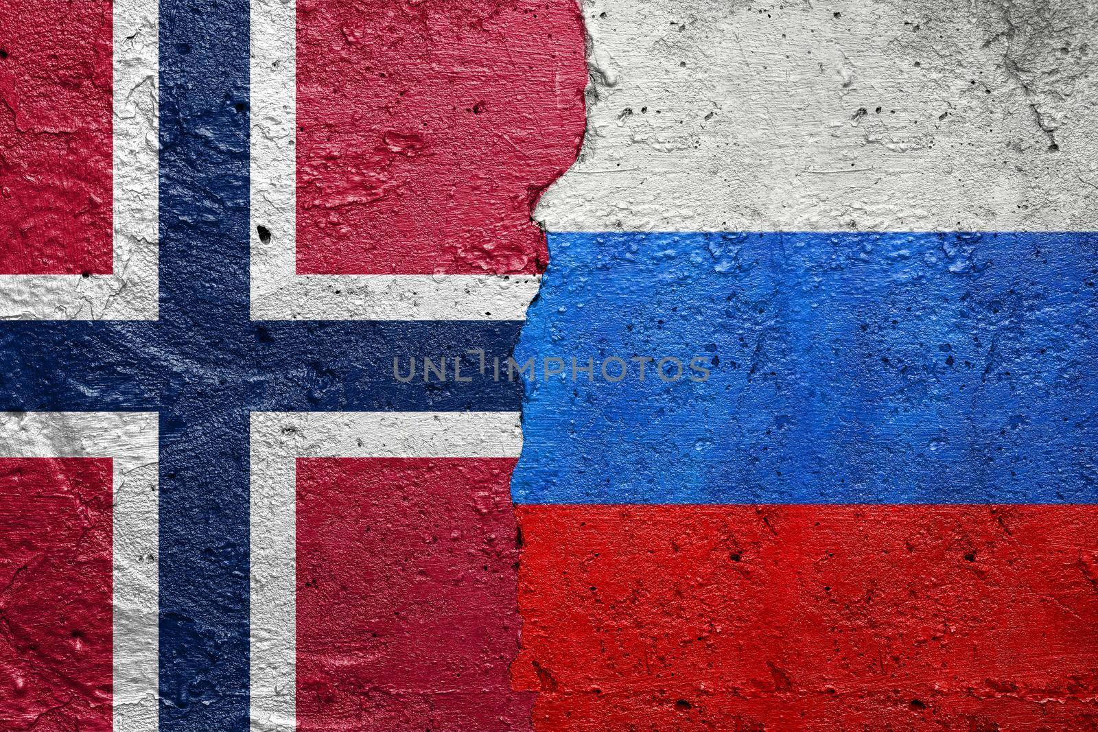 Norway and Russia - Cracked concrete wall painted with a Norwegian flag on the left and a Russian flag on the right stock photo by adamr