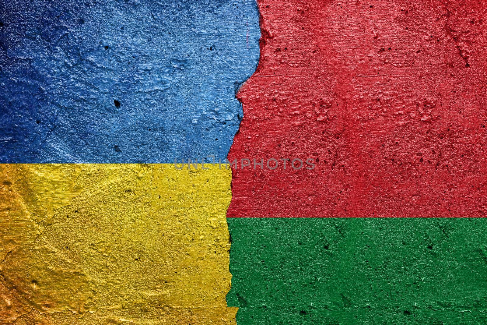 Ukraine and Belarus - Cracked concrete wall painted with a Ukrainian flag on the left and a Belarusian flag on the right stock photo by adamr