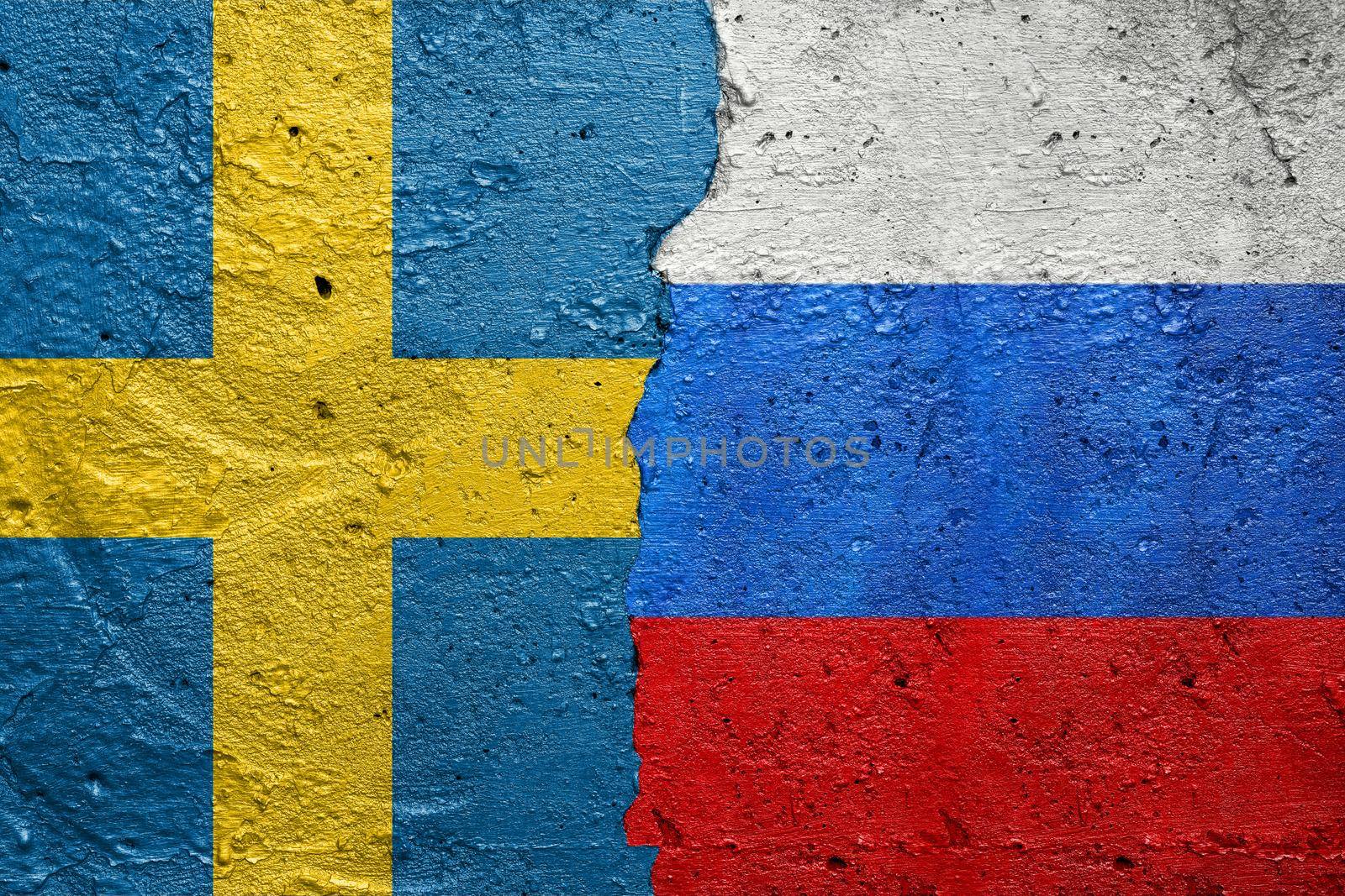 Sweden and Russia - Cracked concrete wall painted with a Swedish flag on the left and a Russian flag on the right stock photo by adamr