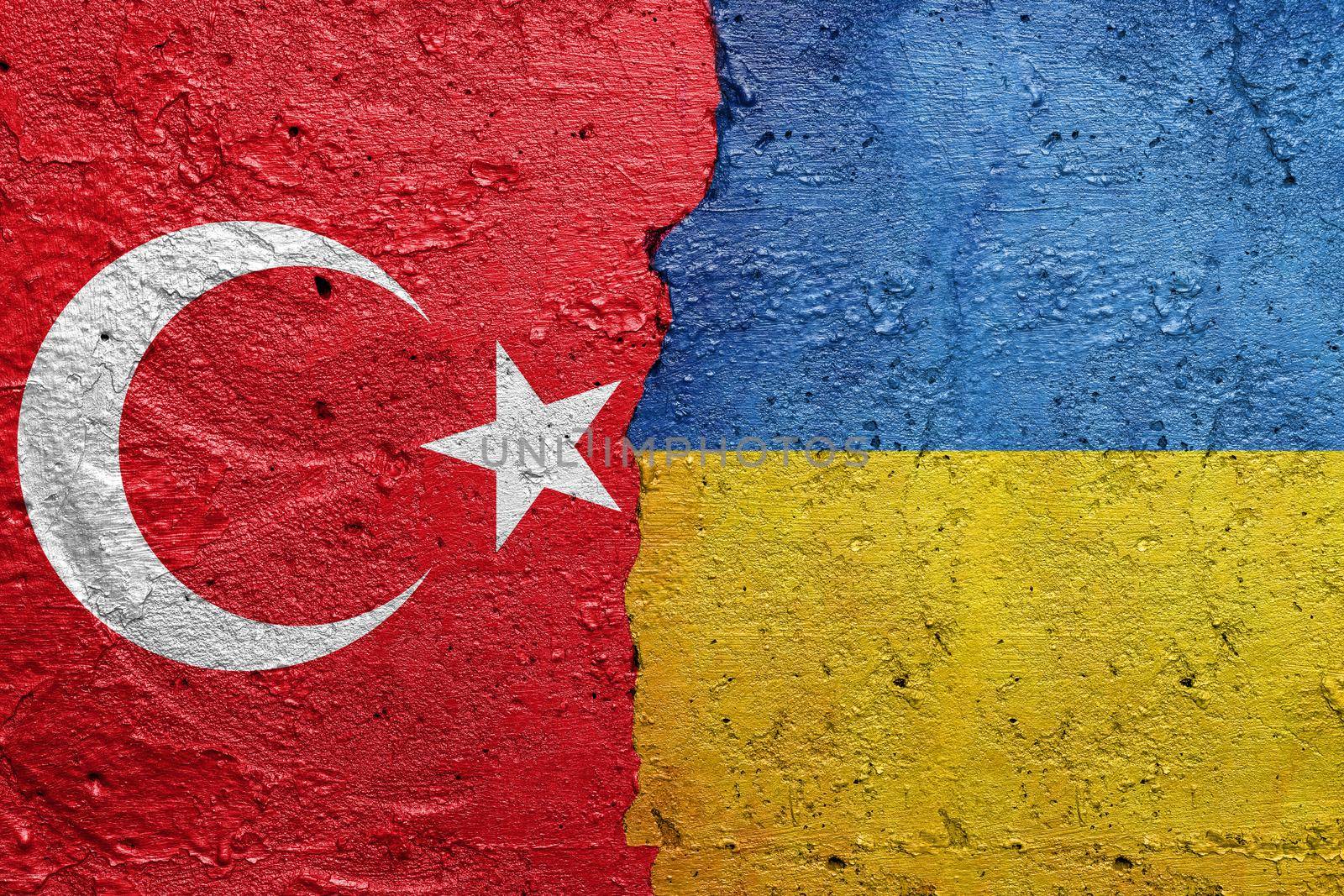 Turkey and Ukraine - Cracked concrete wall painted with a Turkish flag on the left and a Ukrainian flag on the right stock photo by adamr