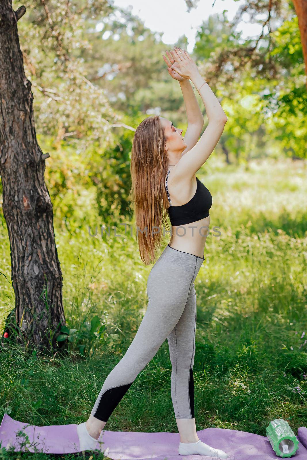 Beautiful young woman practicing yoga at outsite by Anyatachka