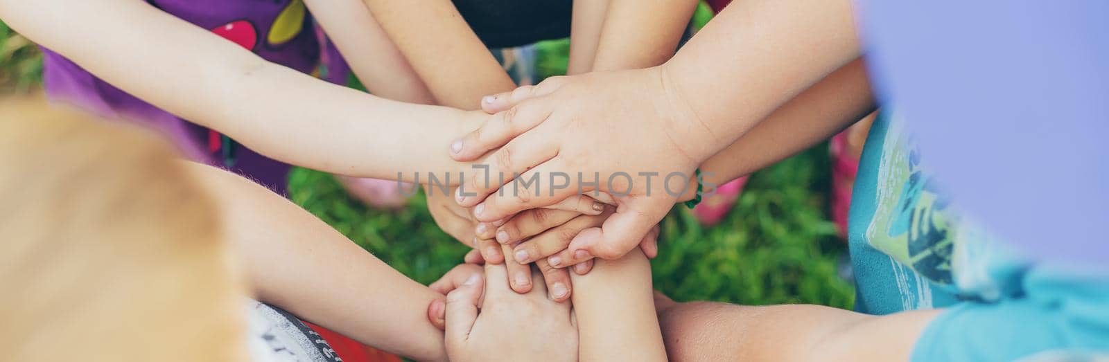 Children's hands together, street games. Selective focus. Kids.