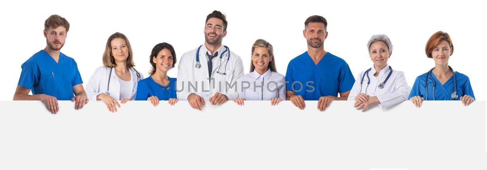 Group of doctors presenting empty banner. Isolated on white background, copy space for text